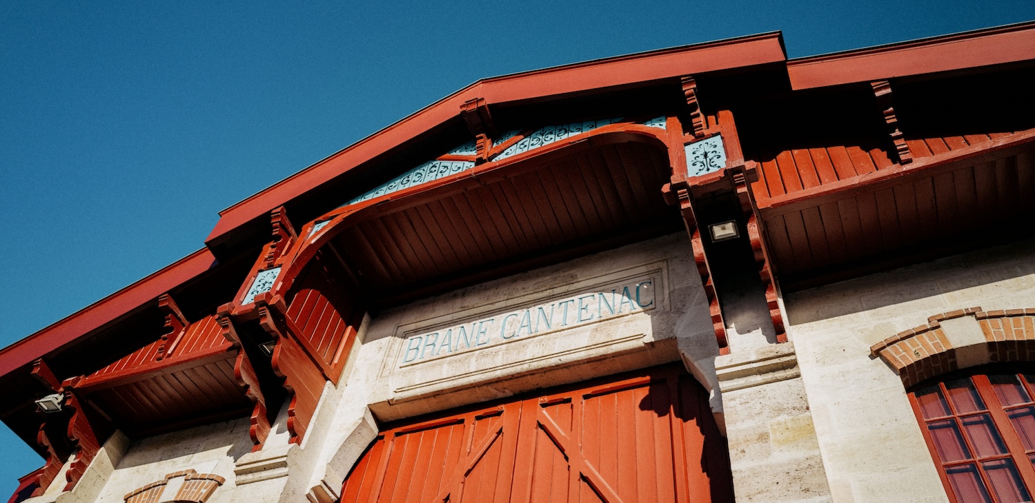 Low angle of the exterior of the winery at Brane-Cantenac, blue sky overhead