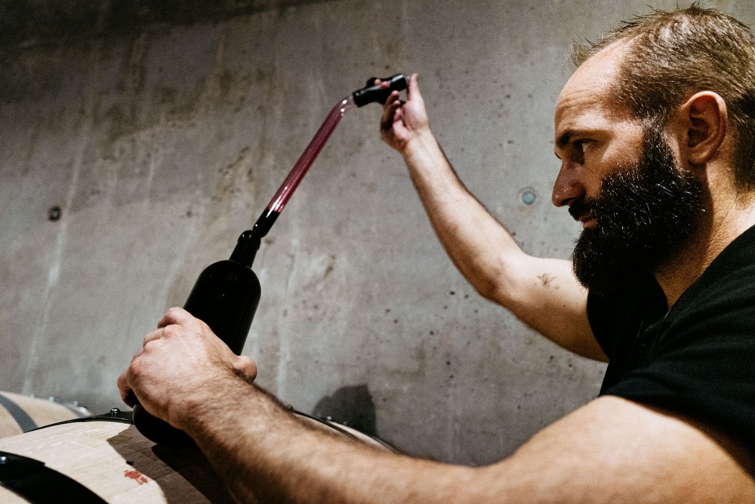 Florent Cillero, cellar master at Brane-Cantenac, using a pipetter to draw a barrel sample.